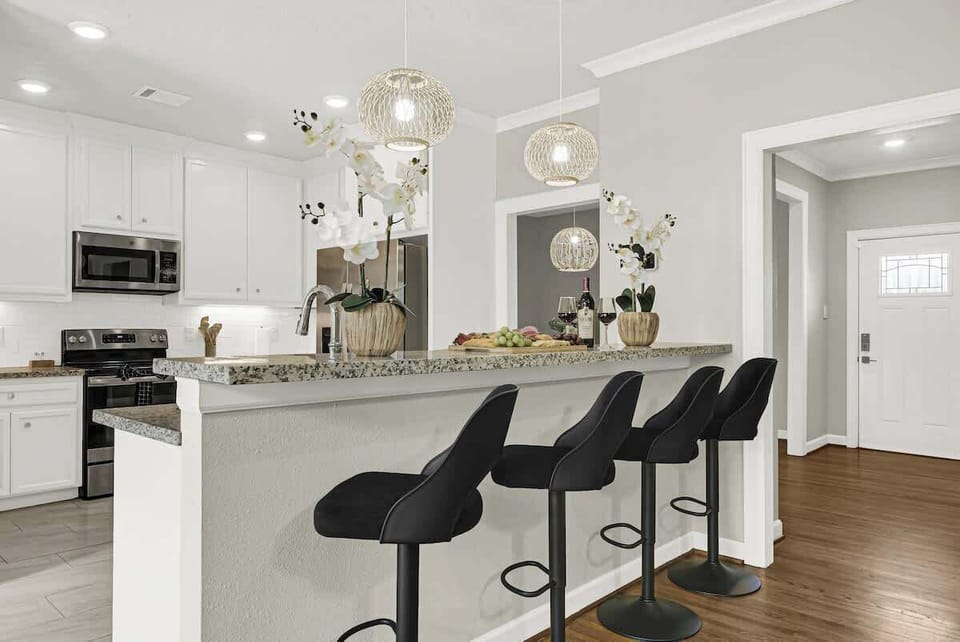 Living and Kitchen View – Open concept living room with breakfast bar.
