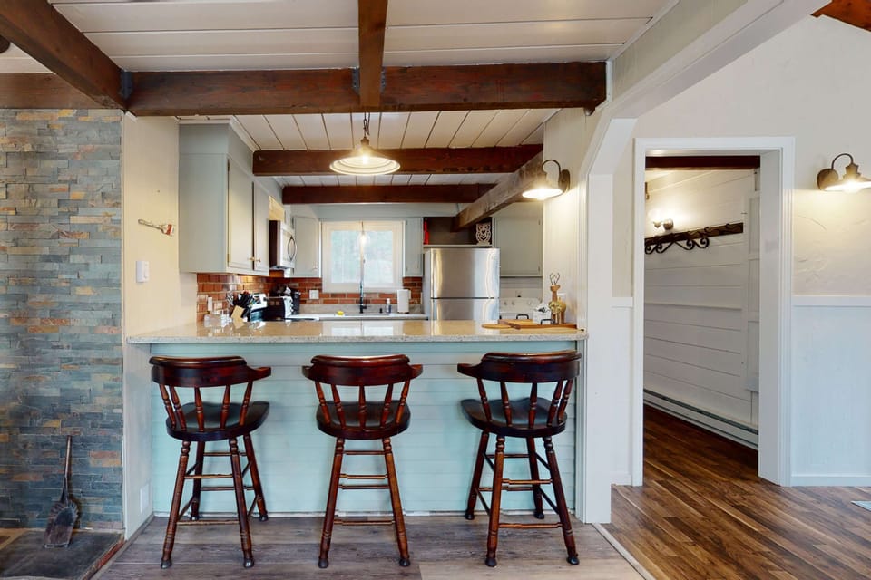 Kitchen breakfast bar with seating, ideal for casual meals, morning coffee, or gathering while meals are prepared.