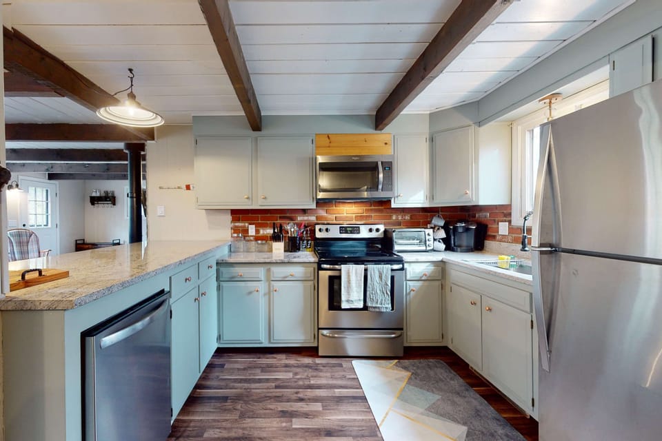 Fully equipped kitchen with stainless steel appliances, ample counter space, and an open layout that makes cooking and gathering easy.