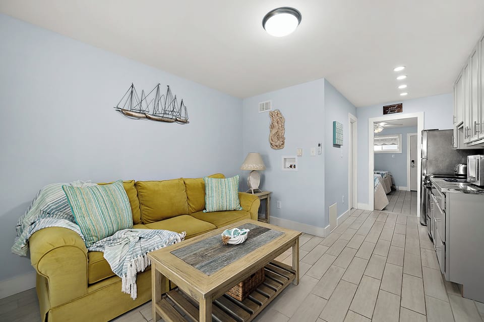 Relaxed gathering space with a plush sofa, coffee table for snacks, and plenty of room to spread out between beach adventures.