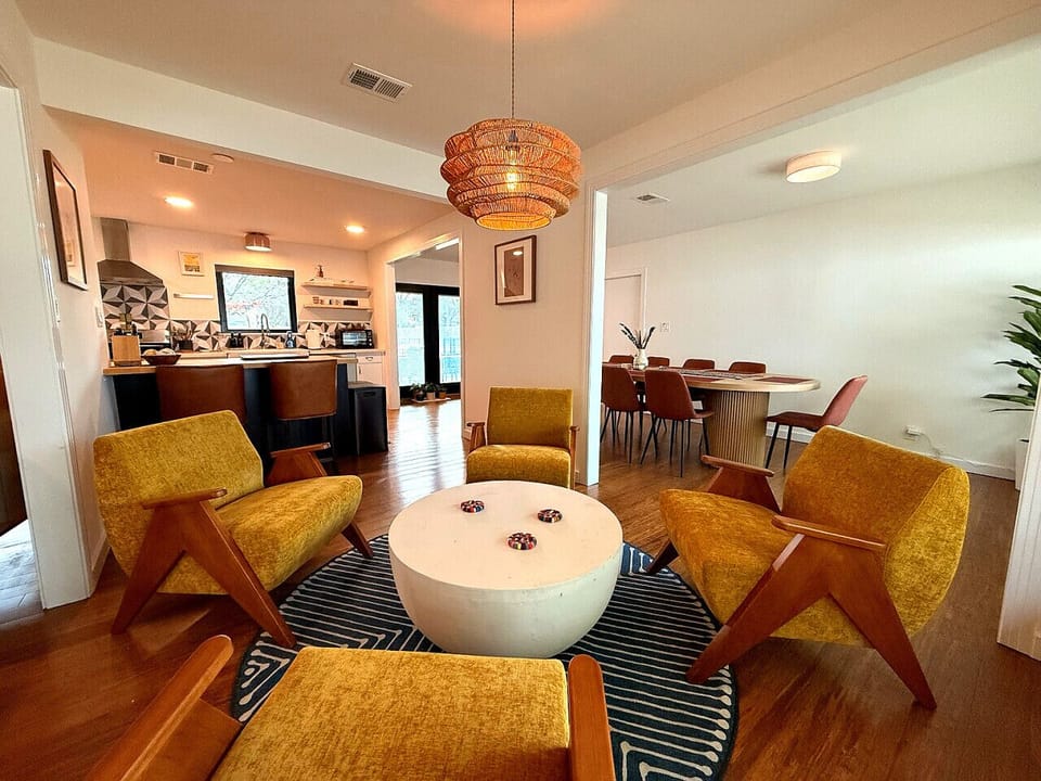 Sitting area off kitchen with bar seating and large kitchen table in dinning room.