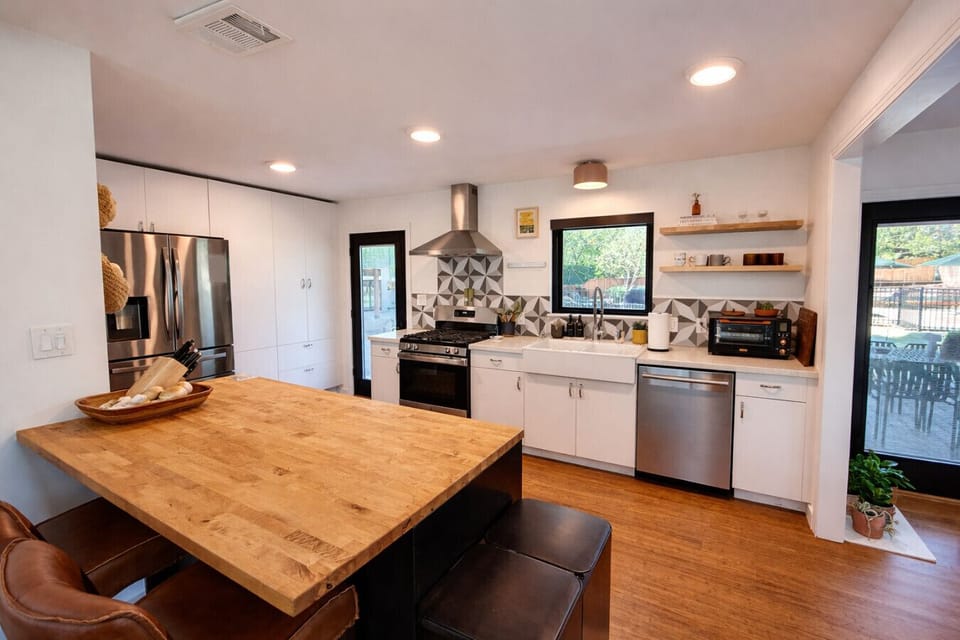 Fully equipped Austin vacation rental kitchen designed for real meals and group gatherings—stocked cookware, ample prep space, and open layout that keeps everyone connected from cooking to cocktails.