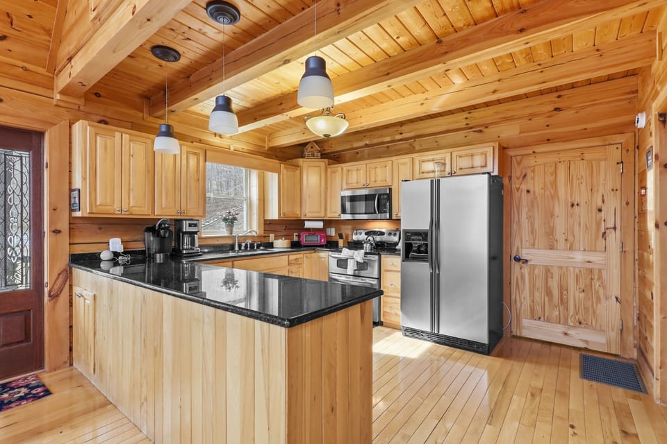 Full kitchen with stainless steel appliances and granite countertops