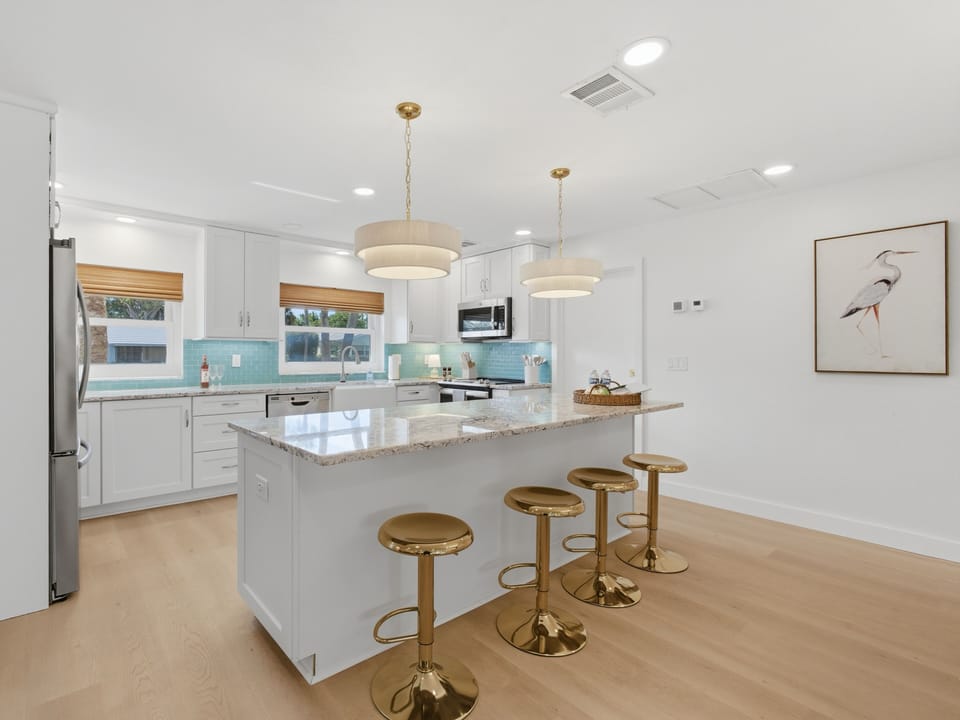 A chef’s dream. Sleek white cabinetry and modern appliances make cooking a breeze. 👩‍🍳✨