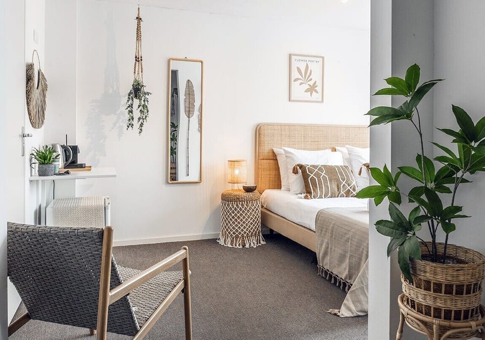 Cozy bedroom with a comfortable double bed, warm lighting, natural textures, and a calm, inviting atmosphere.