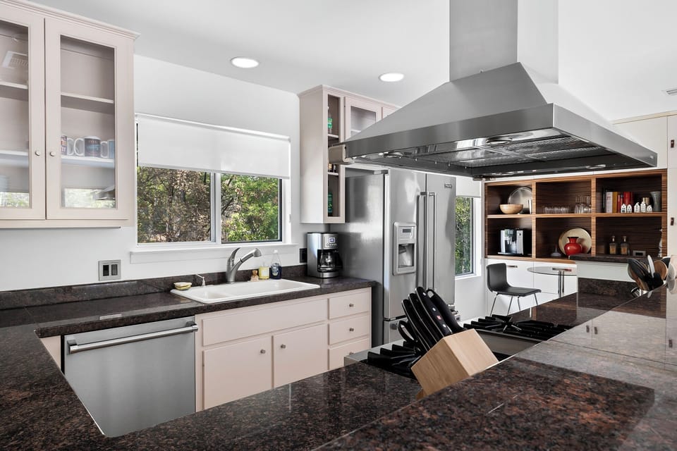 From breakfast to dinner to poolside lounging—this open-concept space brings everyone together. A fully stocked kitchen with a gas stove, modern appliances, and all the essentials makes it easy to feel right at home.