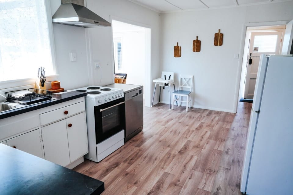 Fully equipped modern kitchen with appliances, ample counter space, and storage. Perfect for cooking meals and entertaining guests.