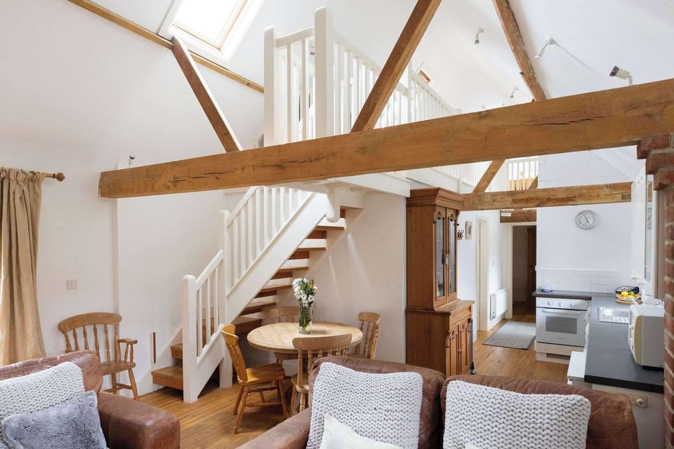 The comfy and social living space in The Dairy, a three-bed cottage to sleep up to 6 guests.