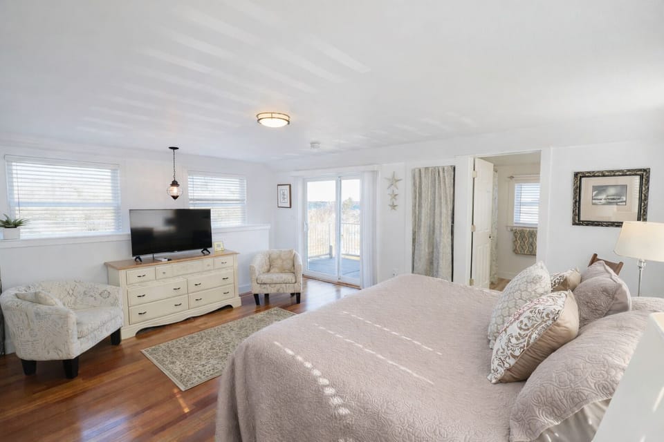Alternate view of primary bedroom with ocean views.