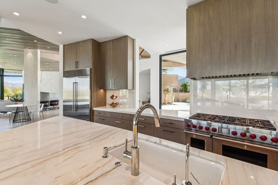 Gourmet kitchen w/ gas range, sleek cabinetry & expansive counter space