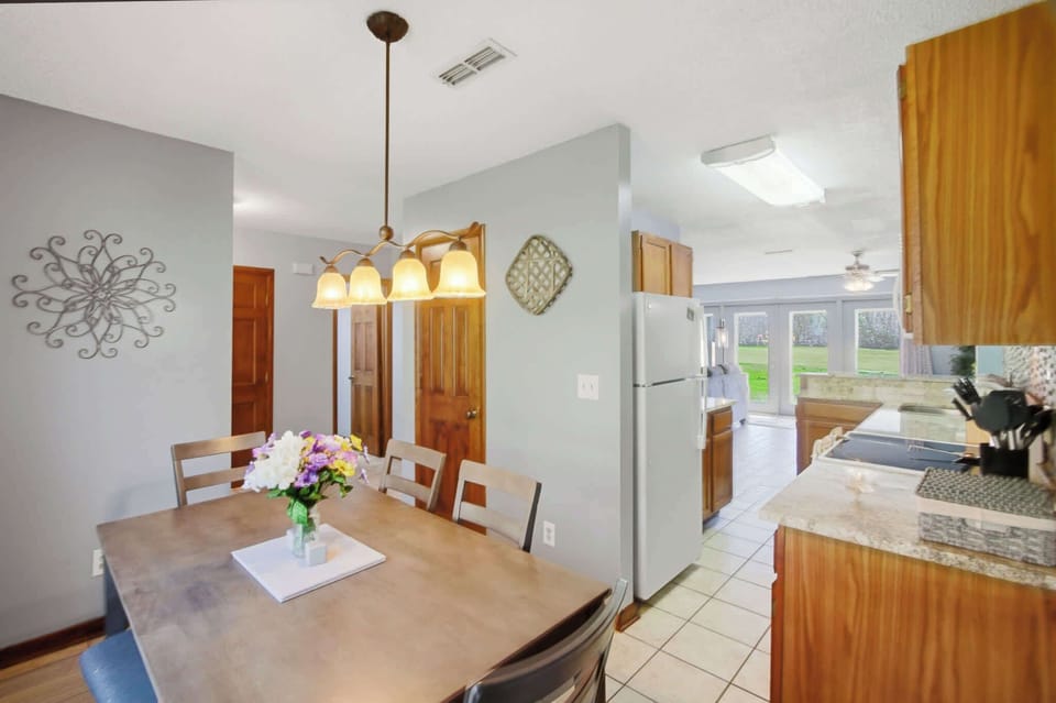 Gather around for delightful meals in a sunlit space with garden views!