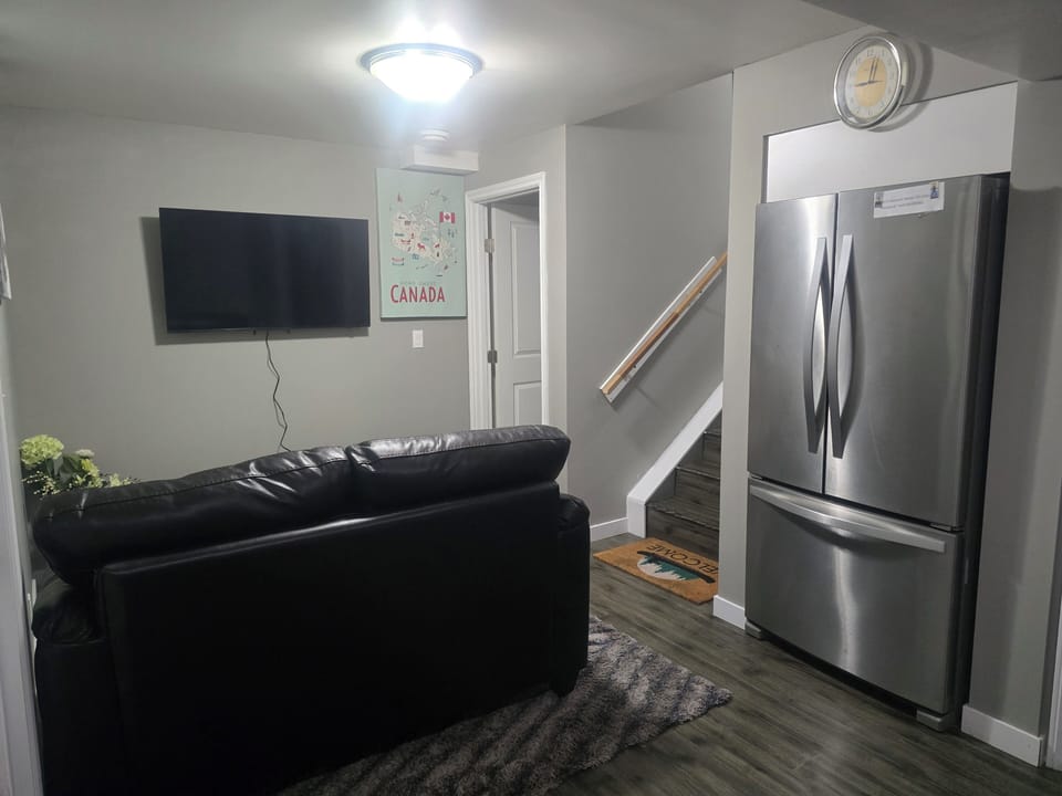 Living area with Smart TV and Fridge