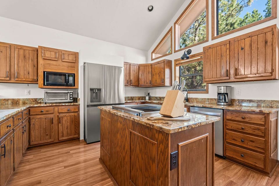 A generous center island anchors this vaulted kitchen, knife block and cutting board ready for the home chef. - Kitchen Island - The Alta - Angel Fire, NM