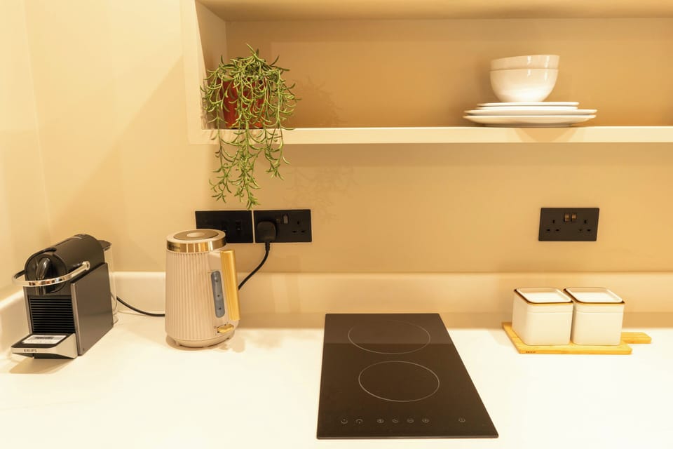Compact kitchenette with Nespresso machine, fridge & essentials