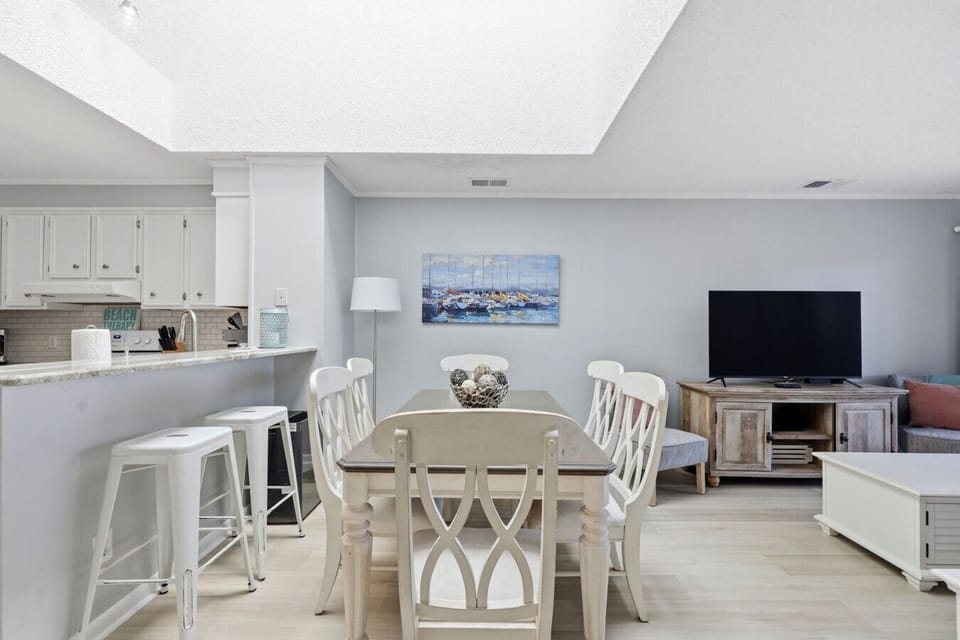 Bright dining area with bar seating and easy access to the fully equipped kitchen