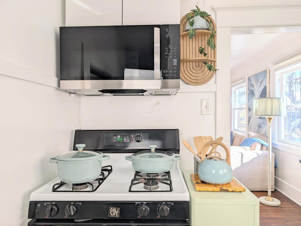Full kitchen with gas stove, microwave, and cooking essentials.