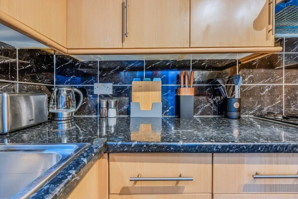 Kitchen countertop with kettle, toaster, and knife set