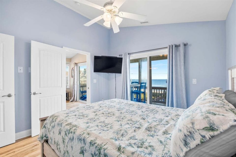 A peaceful bedroom perfect for couples or additional guests, offering soft lighting, comfortable bedding, and easy access to shared bathrooms.