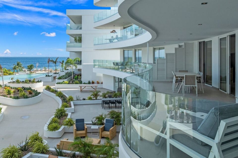 Elegant curved balcony with seating and ocean views—ideal for dining, relaxing, and enjoying a serene coastal lifestyle.