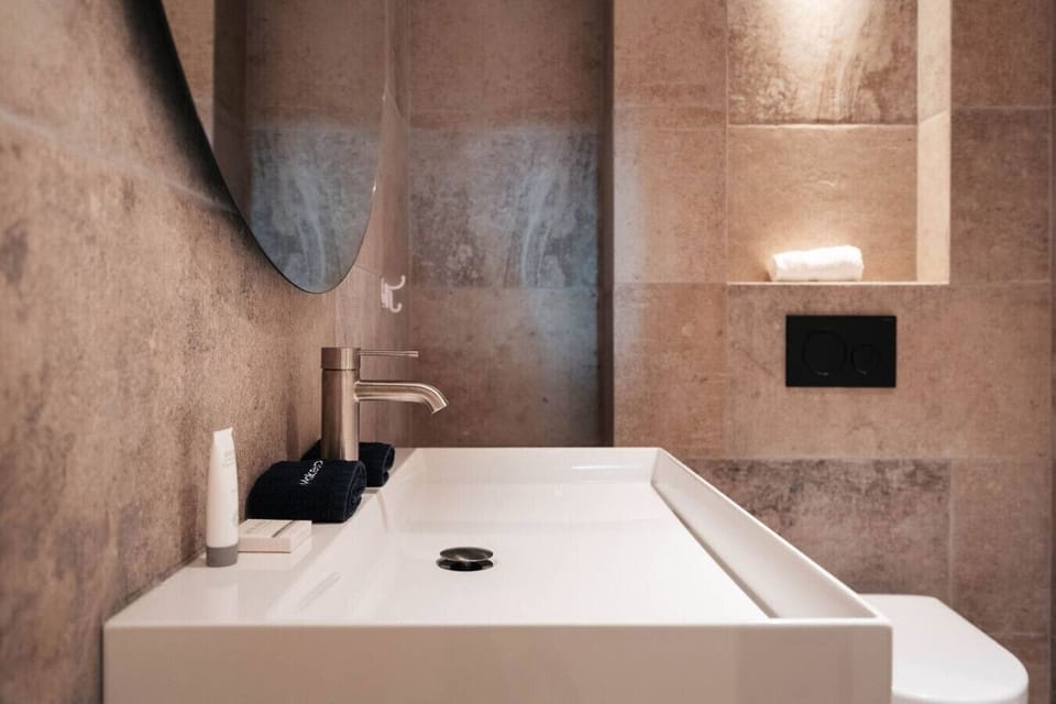 Enjoy a clean, spa-inspired bathroom with modern finishes—perfect for refreshing after a day out.