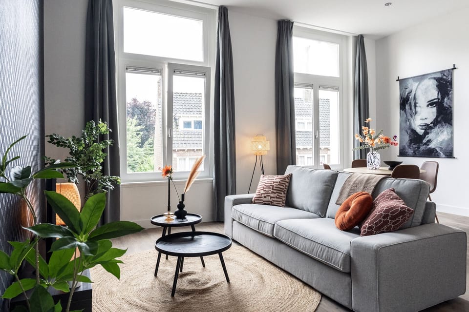 Relax in this cozy, stylish living room with natural light, comfy seating, modern decor, and charming accents that make you feel at home.