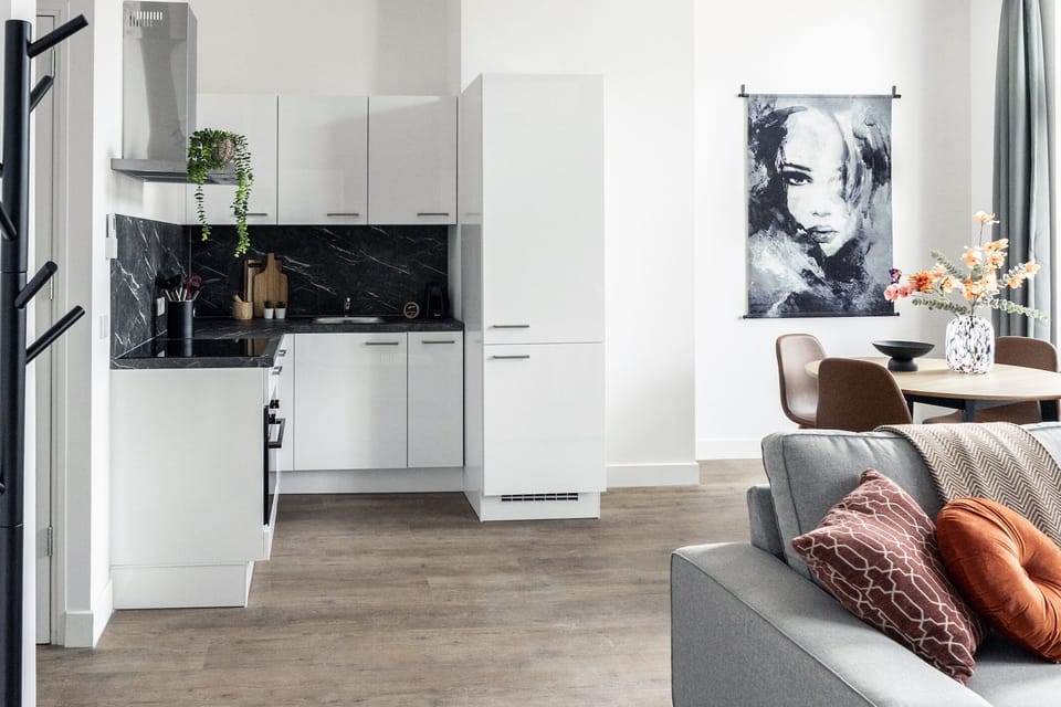 Cook in style with this fully equipped modern kitchen featuring elegant finishes, clever storage, and seamless connection to the inviting living space.