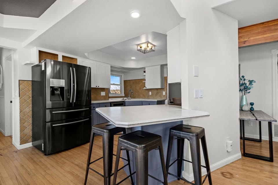 Your modern kitchen features sleek granite countertops, stainless steel appliances, and a spacious island perfect for morning coffee or evening meals.