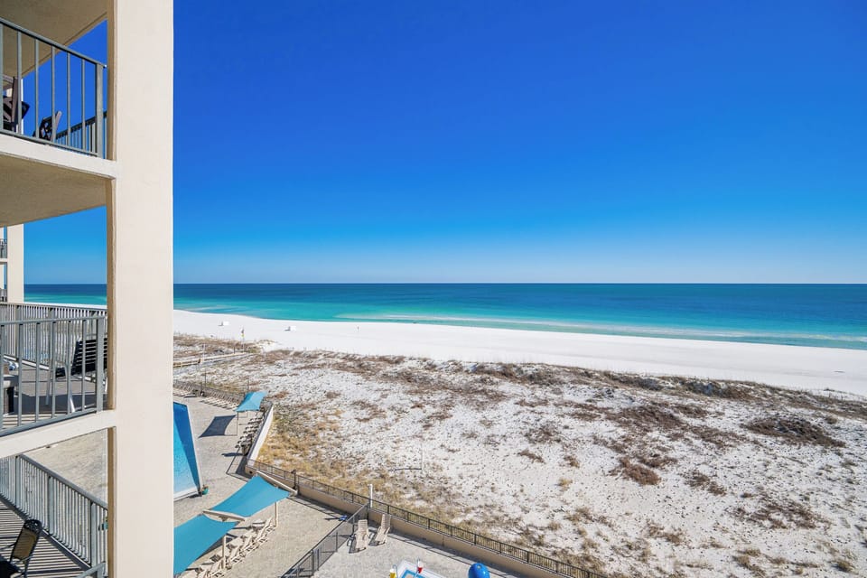 Gaze across the coast from your balcony where sparkling blue waters stretch beneath the clear sky