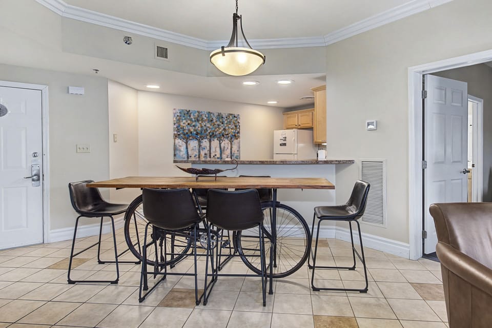 Your stylish dining area flows seamlessly into the kitchen, where warm pendant lighting creates the perfect atmosphere for meals and conversations.