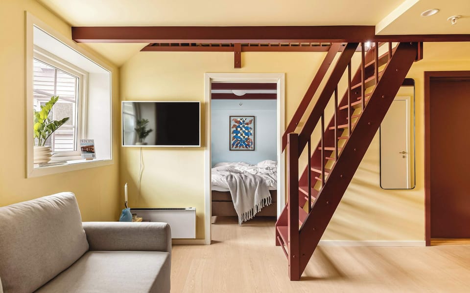 Living room with TV for your entertainment needs and easy access to the bedroom and stairs up to the loft bedroom.