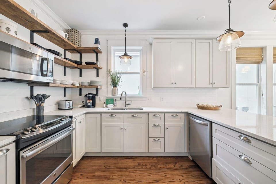 Your fully equipped kitchen invites culinary adventures with modern appliances, open shelving, and plenty of counter space for meal prep.