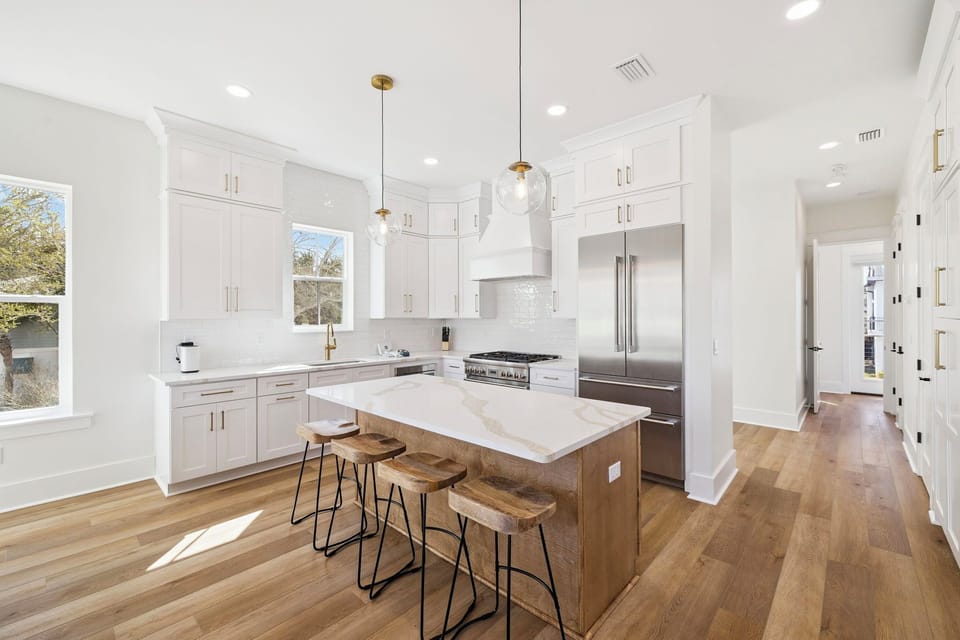 Cook memorable meals in your gleaming kitchen featuring crisp white cabinets, marble countertops, and top-tier stainless steel appliances.