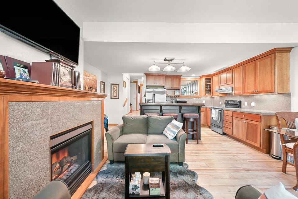 Cozy living room with fireplace and open kitchen layout