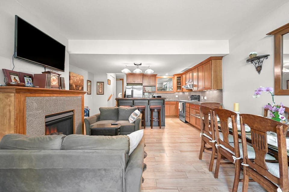 Spacious open living and kitchen area with cozy fireplace