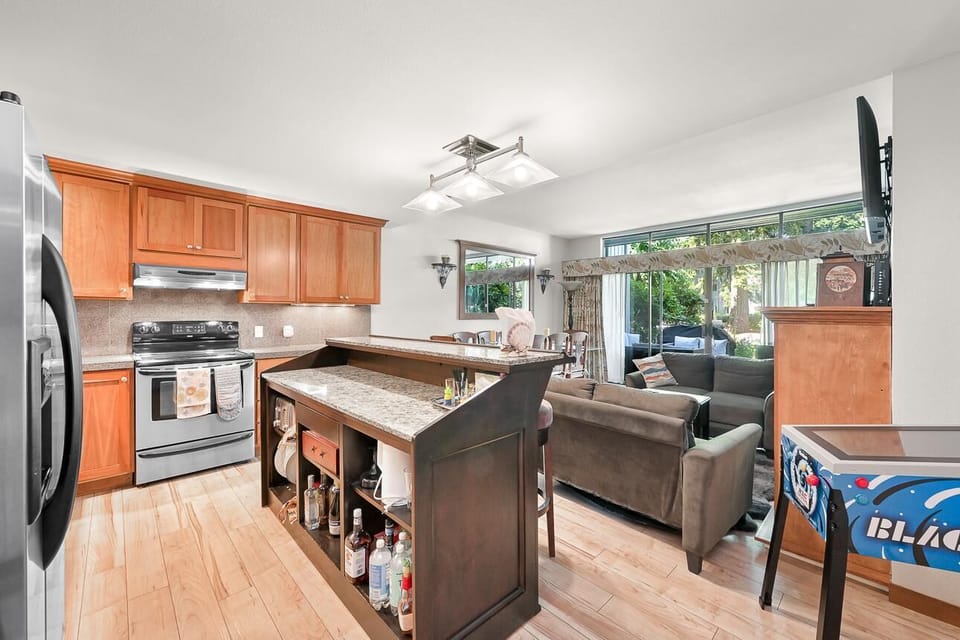 Open-concept kitchen and living area with garden views