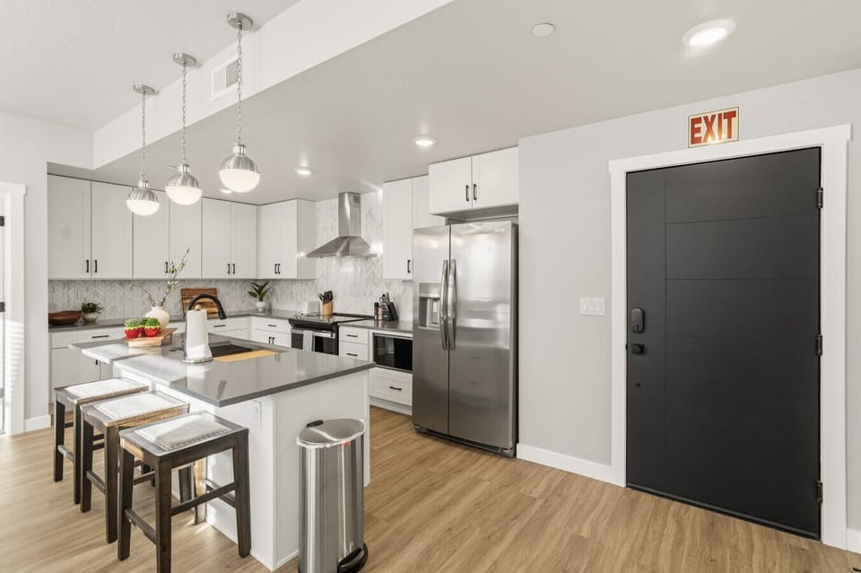 Bright kitchen with island seating and stainless steel appliances
