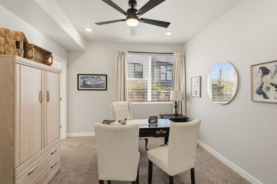 Cozy home office with desk, comfortable seating, and plenty of natural light