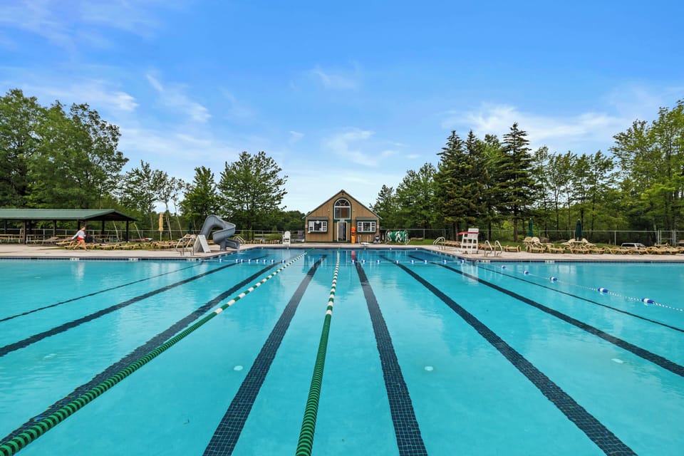 Large community pool with lap lanes and scenic surroundings
