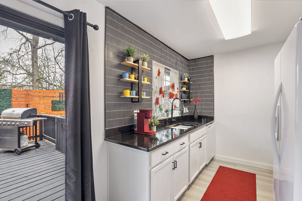 Modern kitchen with coffee station and direct access to the private patio and grill for easy indoor-outdoor living