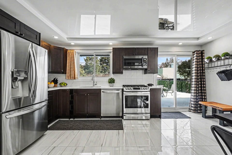 Modern chef's kitchen with stainless appliances, island, and open layout in Ottawa