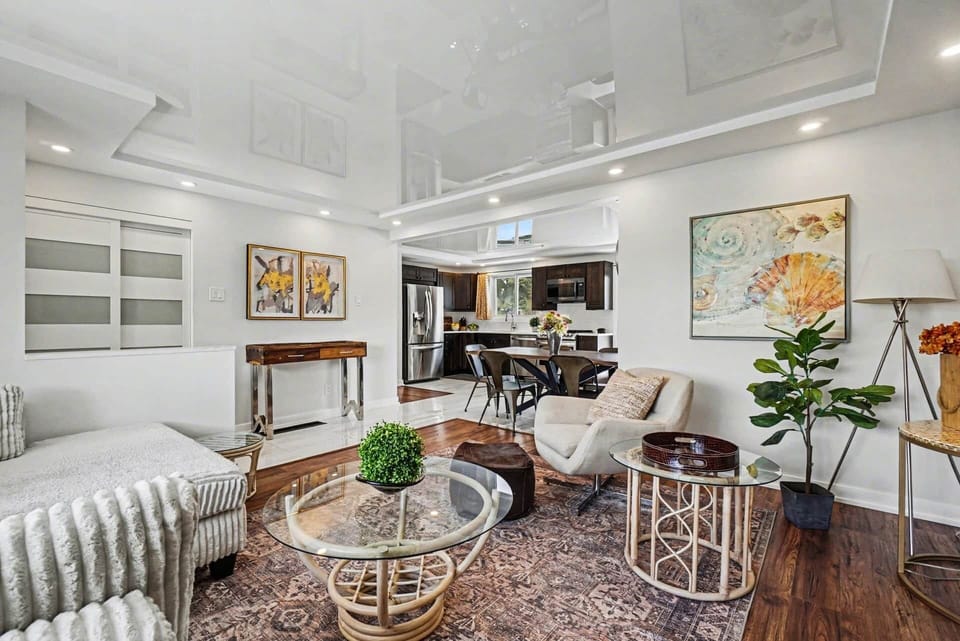 Open-concept living area with chic finishes, plants, and wall-mounted TV in Ottawa