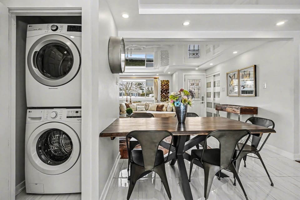 Modern kitchen and dining space featuring in-suite laundry for guest convenience in Ottawa