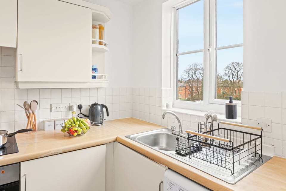 Bright, modern kitchen with sunny window and warm wood countertops