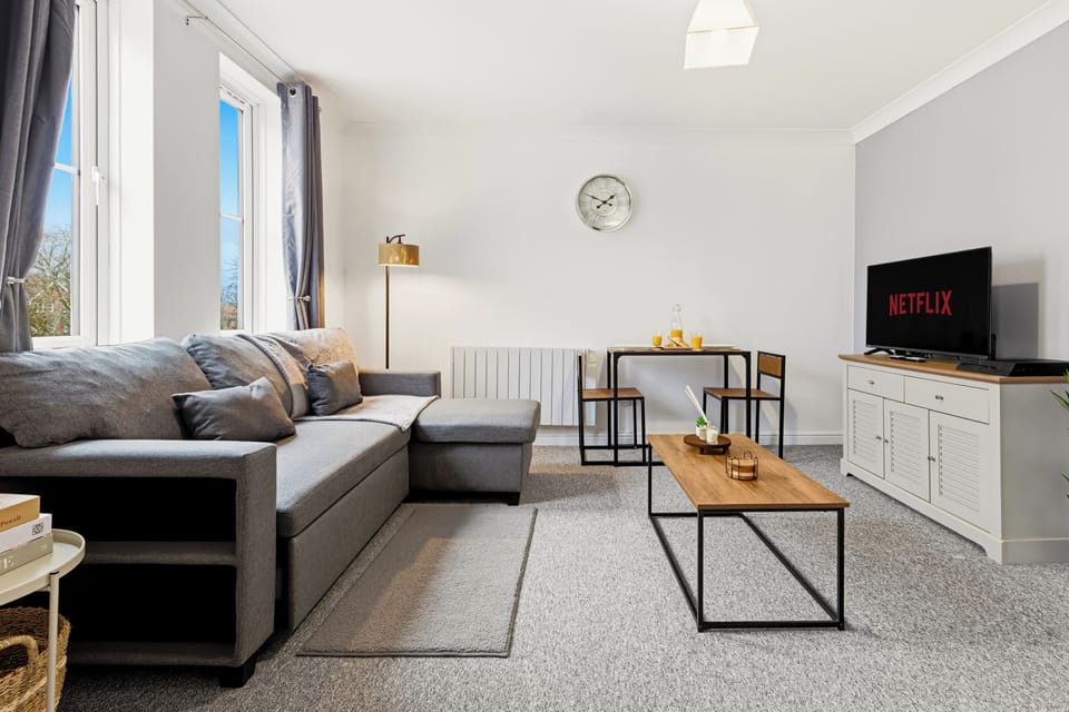 Bright modern lounge with comfy sofa, dining nook & smart TV