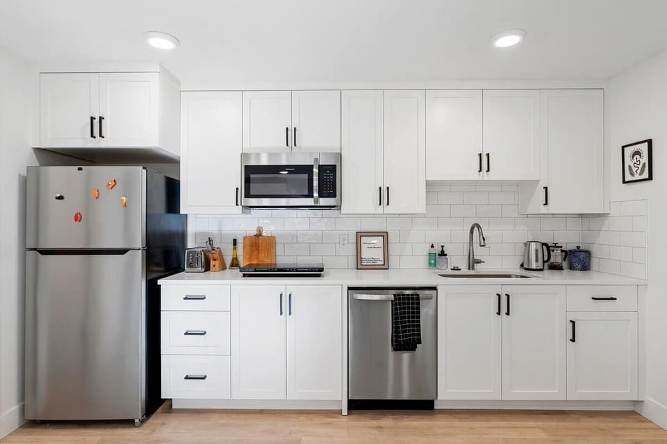 Fully stocked modern kitchen with stainless steel, dishwasher & microwave—everything you need for a comfortable stay.