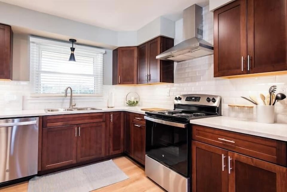 Bright and functional kitchen featuring sleek countertops and ample cooking space.