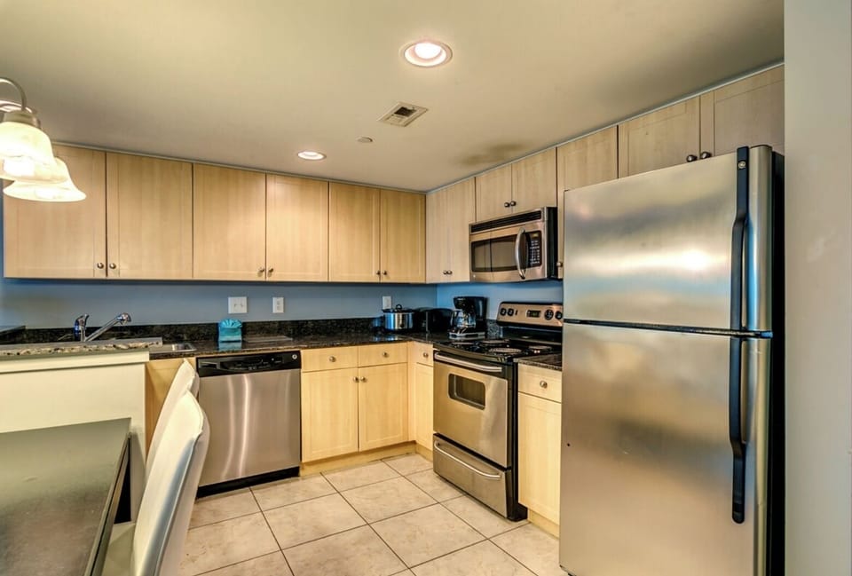 elegant flooring, sleek furniture, and stainless steel appliances.