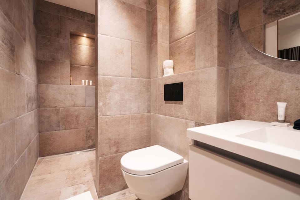 Enjoy a modern bathroom with a spacious walk-in shower and clean, elegant finishes.