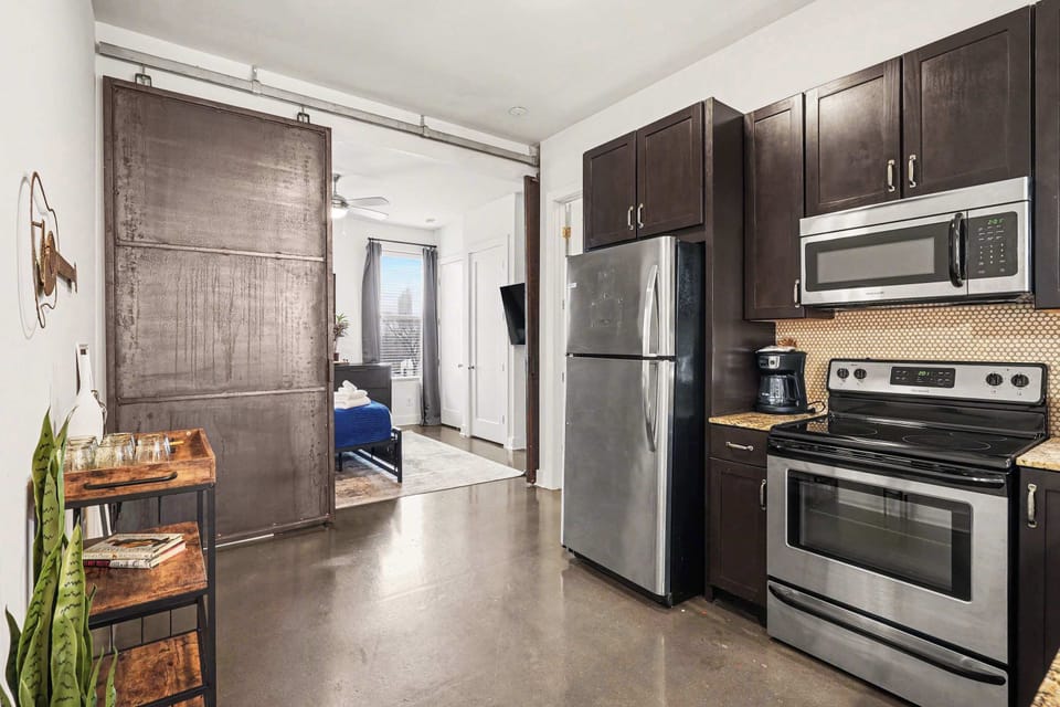 Cook like a pro in this modern kitchen with stainless appliances and sleek granite counters.