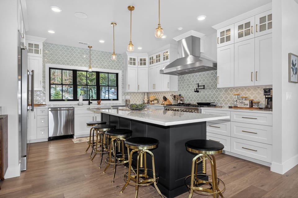 Your chef-worthy kitchen awaits with sleek white cabinets, marble countertops, and gleaming appliances perfect for creating memorable meals together.